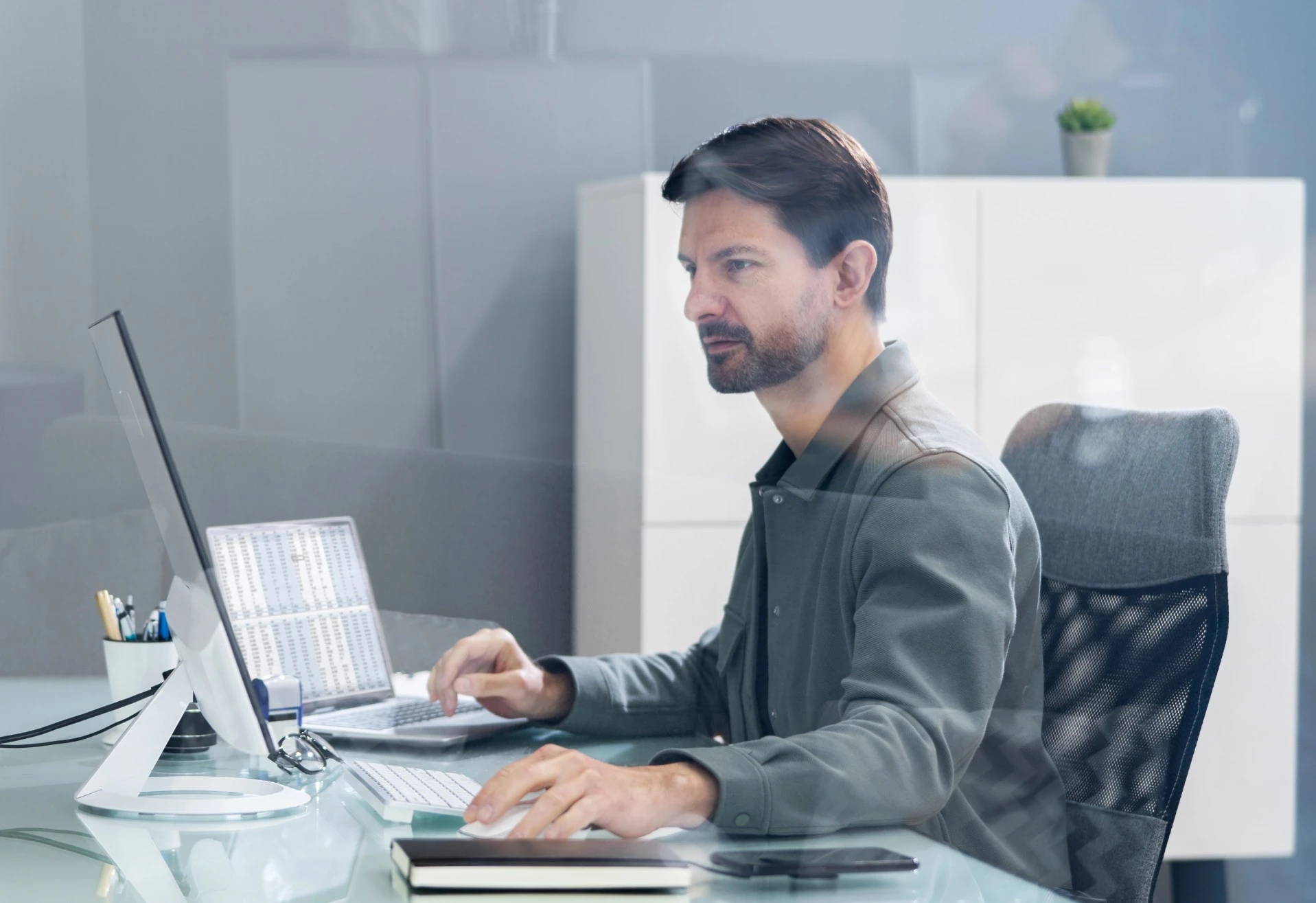 Professional completing virtual instructor-led training program at a desktop workstation