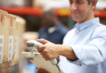 warehouse manager performing cycle count with barcode scanner for inventory control