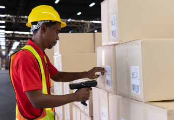 warehouse worker scanning inventory for ERP and WMS supply chain data alignment