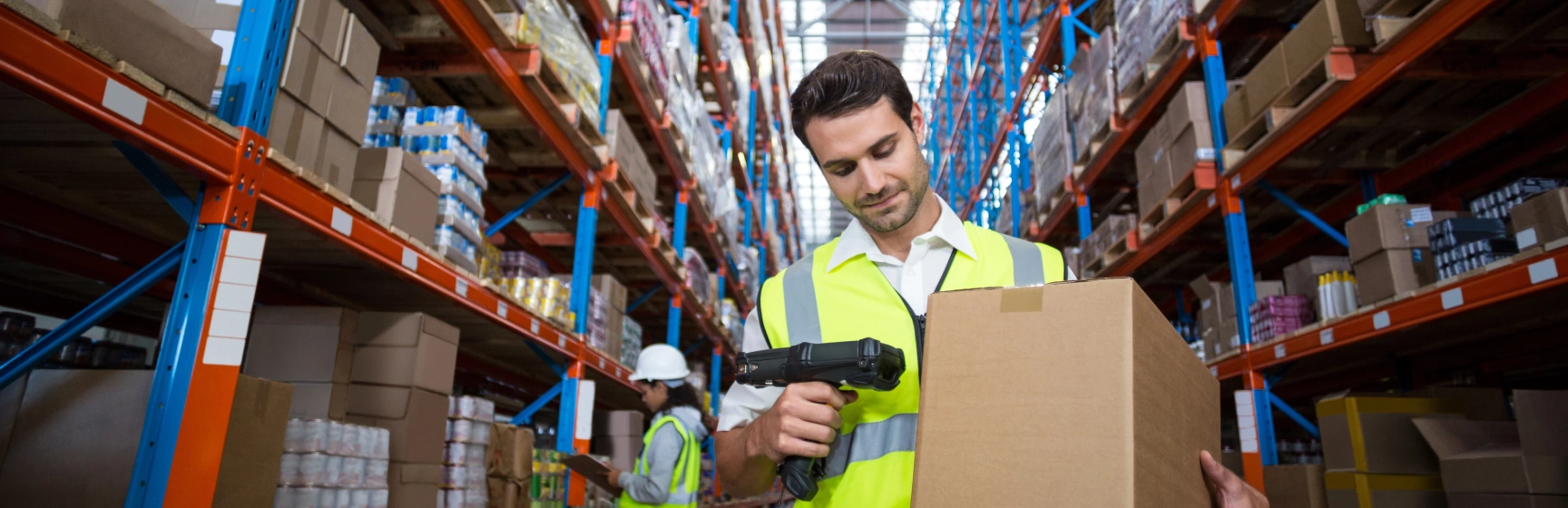 Inventory management consulting warehouse worker scanning boxes in distribution center