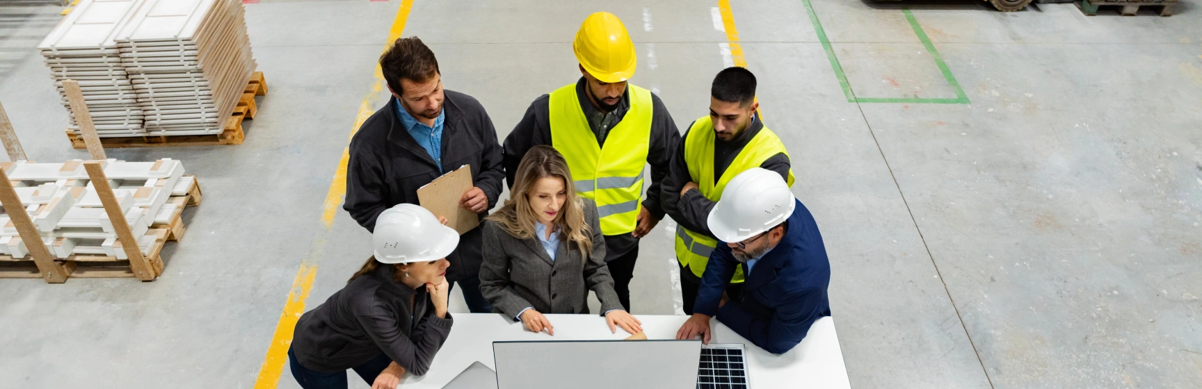Cross-functional team in hard hats collaborating on a sales and operations planning consulting engagement
