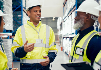 two warehouse supervisors in safety vests aligning on receiving and picking standards on the warehouse floor