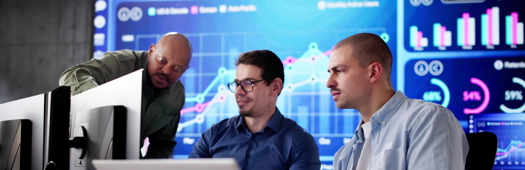 Technology consultants reviewing ai data dashboards representing ai implementation consulting for mid-sized businesses