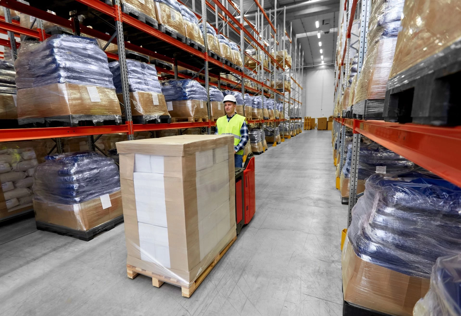 Warehouse worker moving inventory through facility to address poor inventory management process