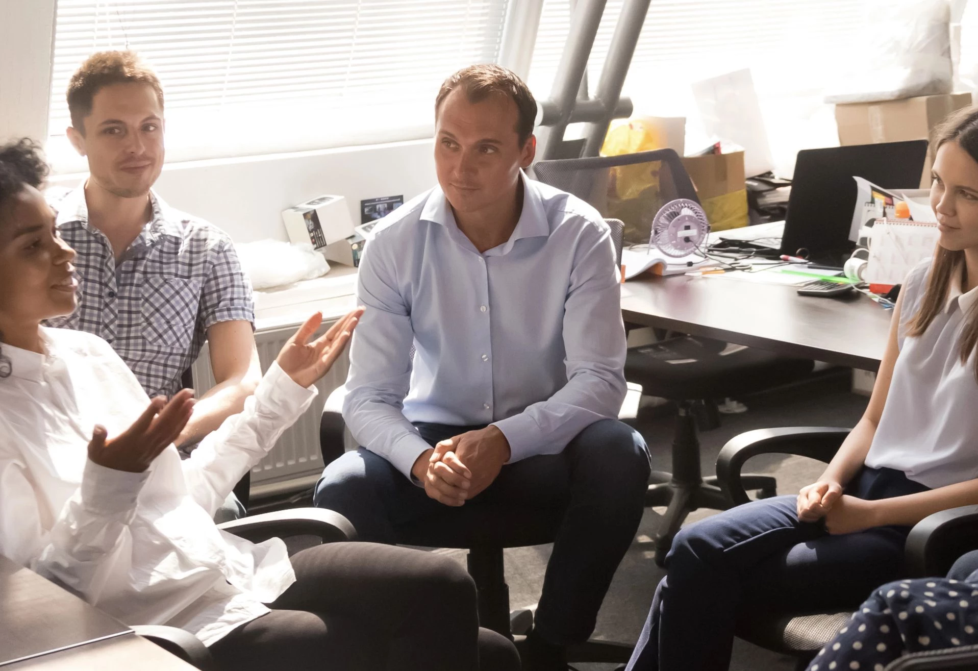 Team members looking disengaged during a workplace meeting — employee engagement crisis