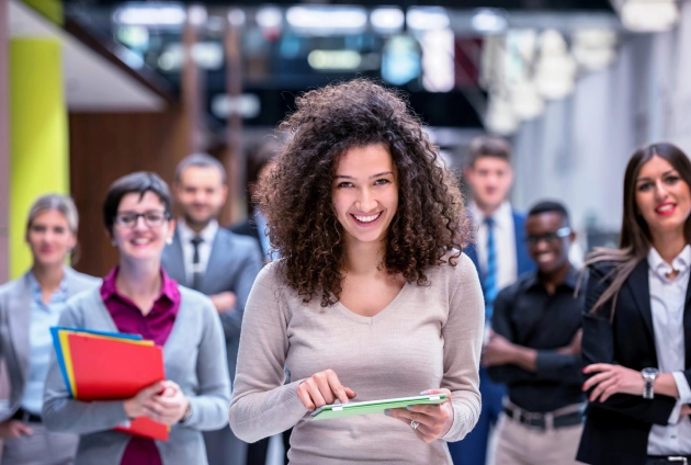 confident emerging leader with a diverse professional team representing organizational leadership development for mid-sized businesses